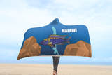 Aulonocara Lwanda Cichlid Lake Malawi Hooded Blanket shown with a person walking on the beach